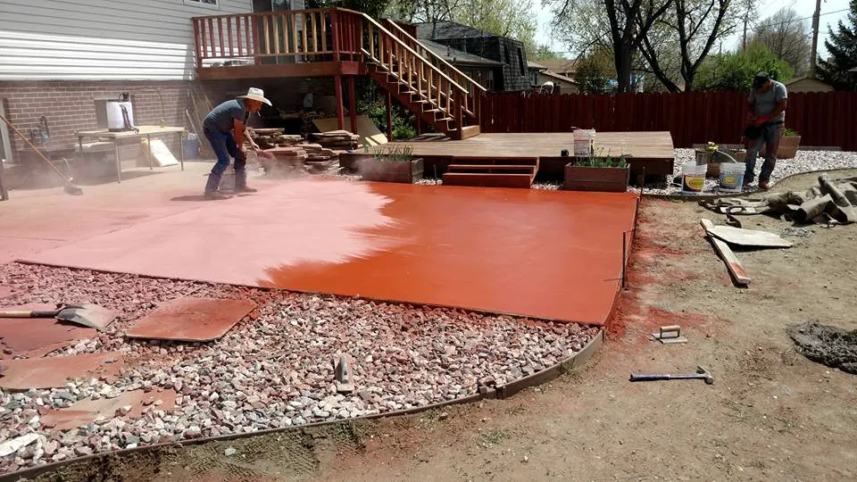 Crew adding color to a fresh patio pour
