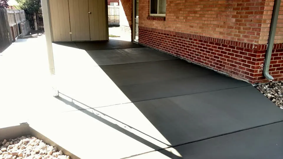 Patio under a covered porch on a brick home