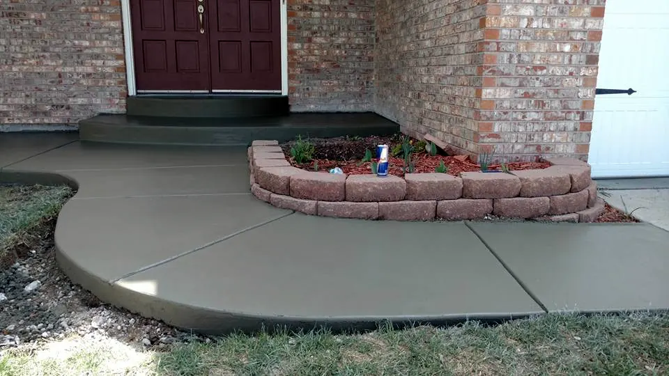 Curved front walk and step beside a brick planter