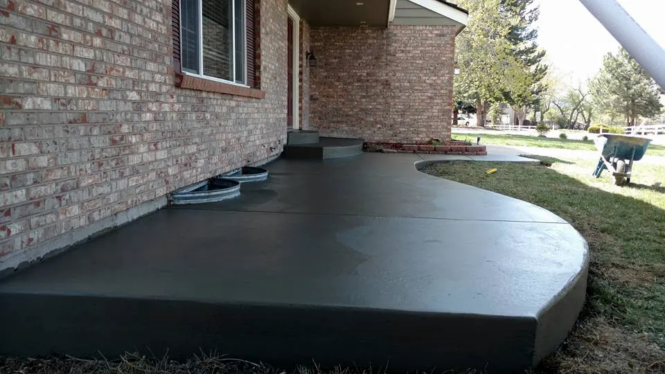 Curved patio along a brick home