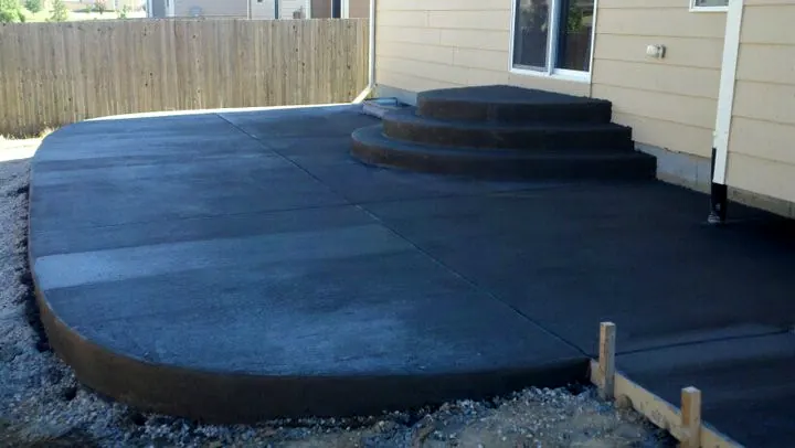 Curved patio with wide steps up to the door