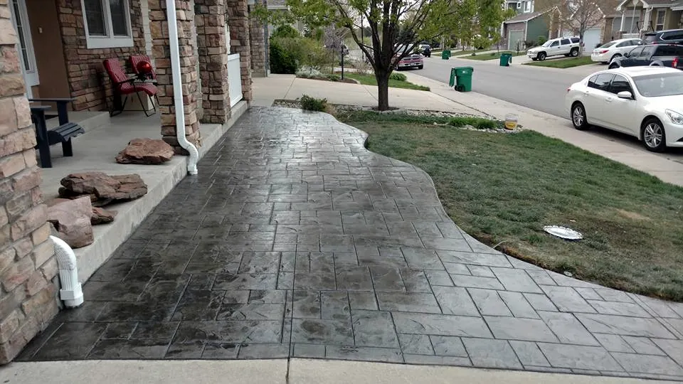 Curved stamped front walk running past the porch
