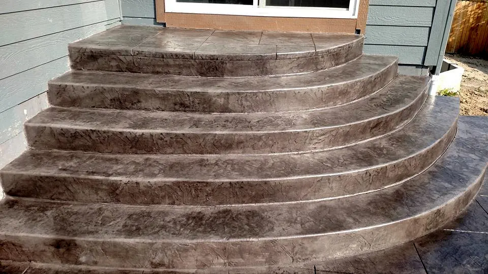 Fanned stamped steps curving down to a patio