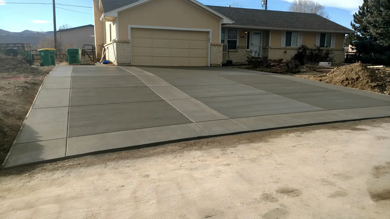 New driveway at a ranch home with the foothills behind
