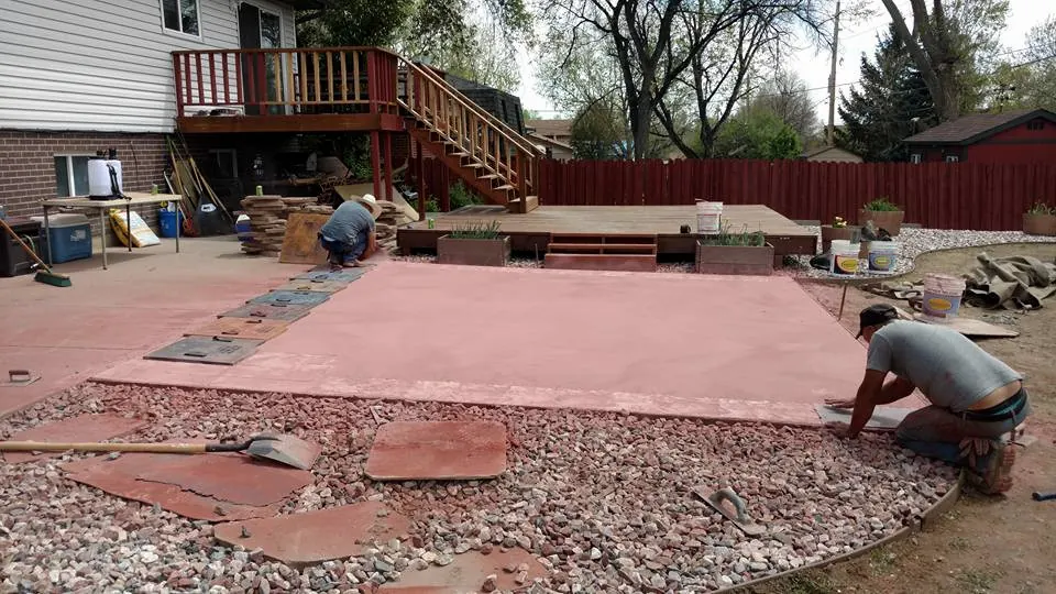 Hand finishing the edge of a colored patio