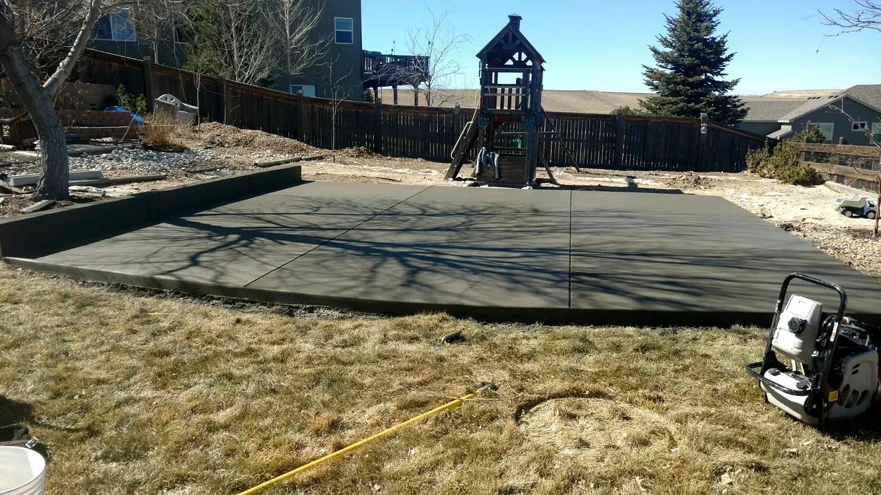 Large backyard patio with a curved edge