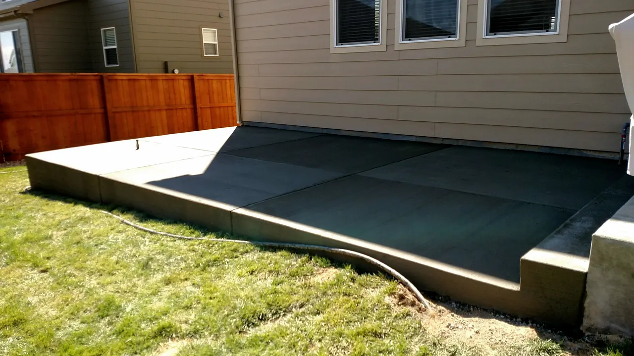 Patio slab meeting a fresh lawn