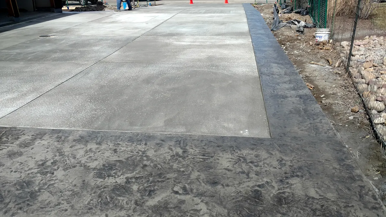 Patio slab with a stamped border band