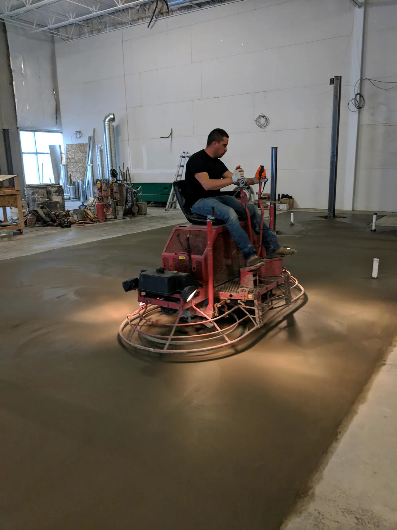 Finishing an interior slab with a ride-on power trowel