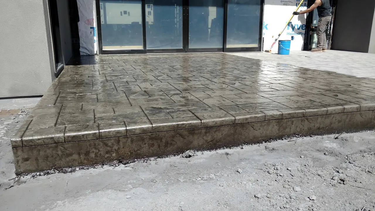 Raised stamped patio outside the sliding doors of a new build