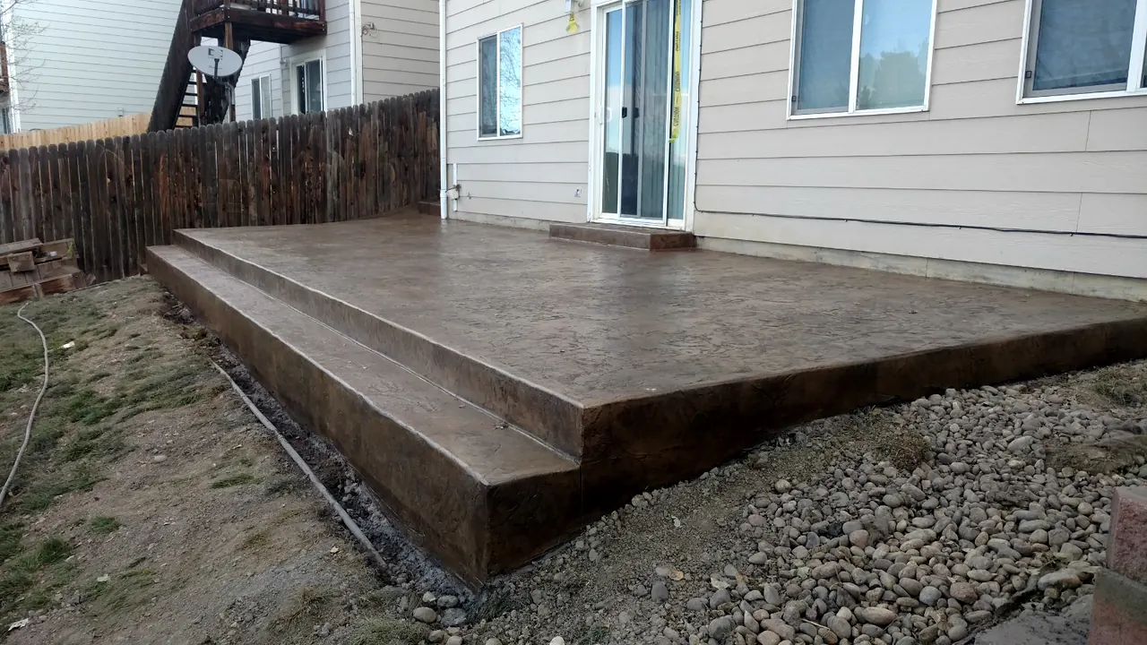 Raised stamped patio with a full-width step