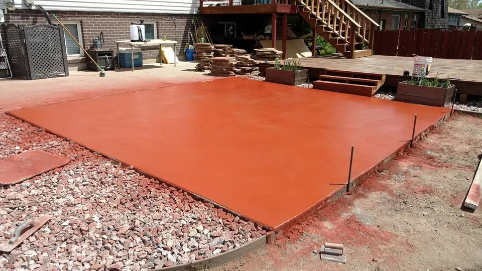 Newly poured red colored concrete patio
