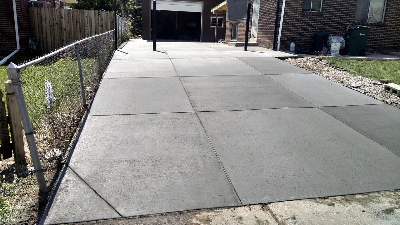Broom-finished side driveway to a rear garage