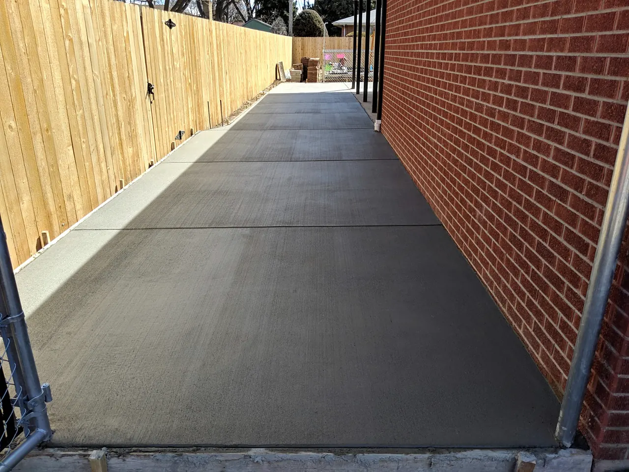 Side walkway along a brick wall