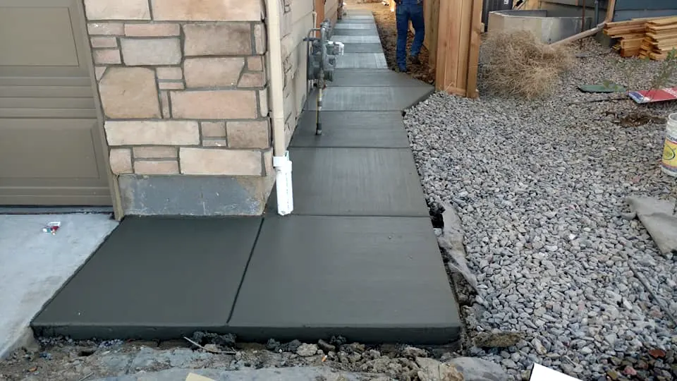 Side walk along a stone-faced home