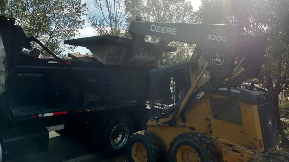 Skid steer and trailer on a tear-out