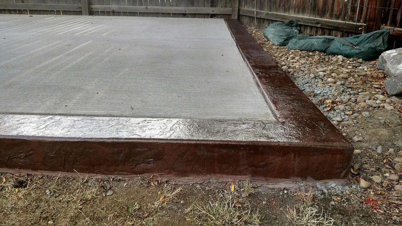 Broom-finished slab framed by a colored, stamped border
