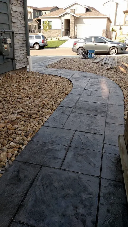 Curved stamped sidewalk in a front yard