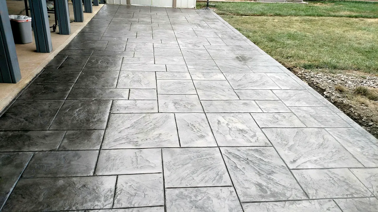 Long stamped patio running the length of a covered back porch