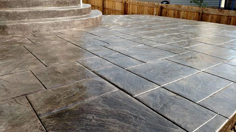 Stamped tile-pattern patio with curved steps